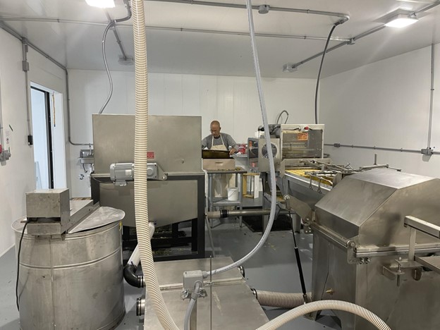 person using honey extraction equipment